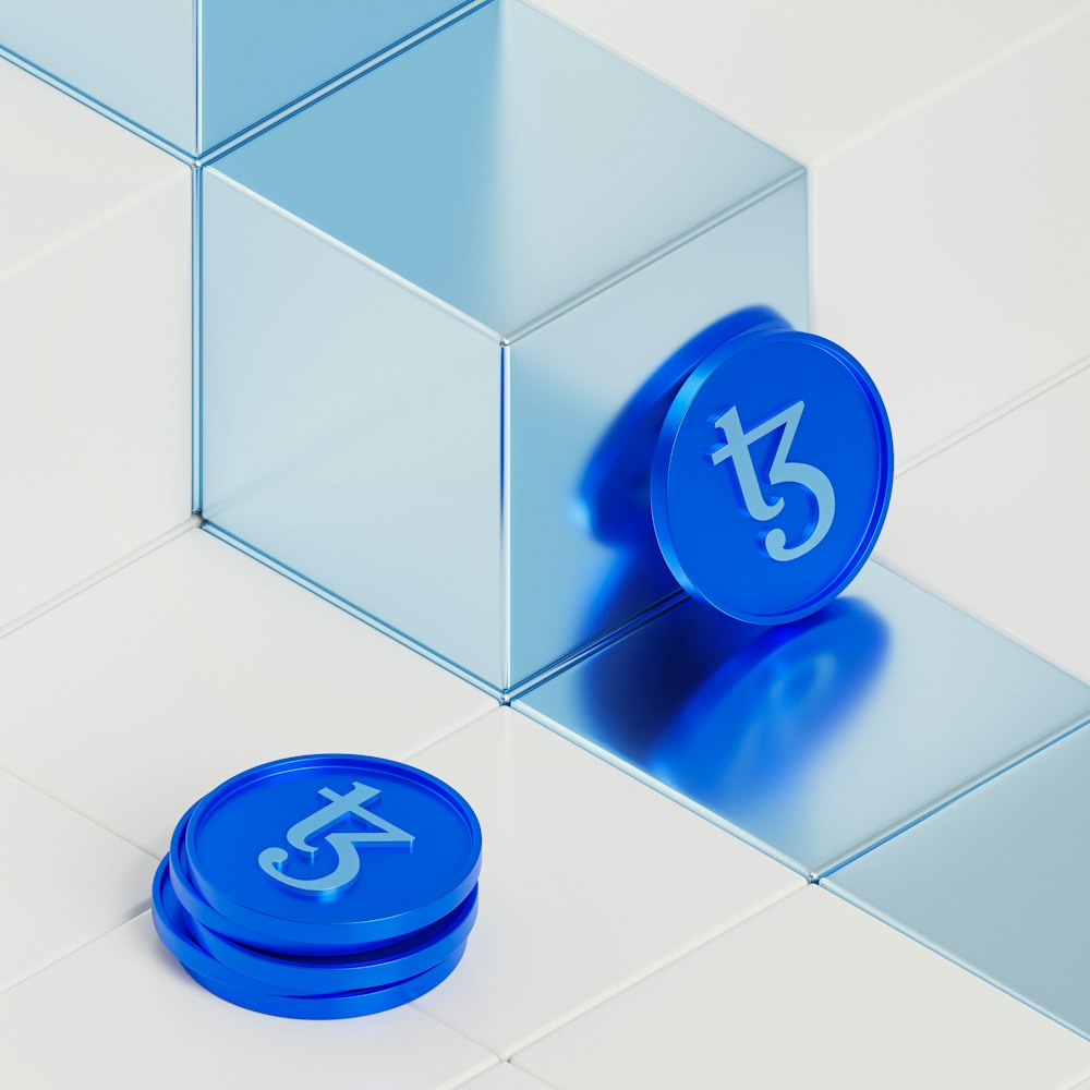 a blue clock sitting on top of a white tiled floor