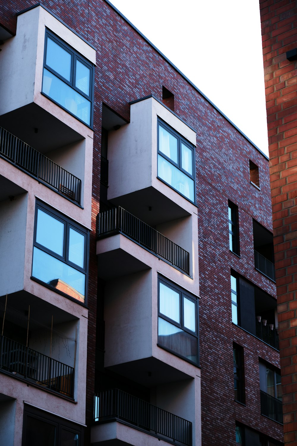 a red brick building with balconies and balconies