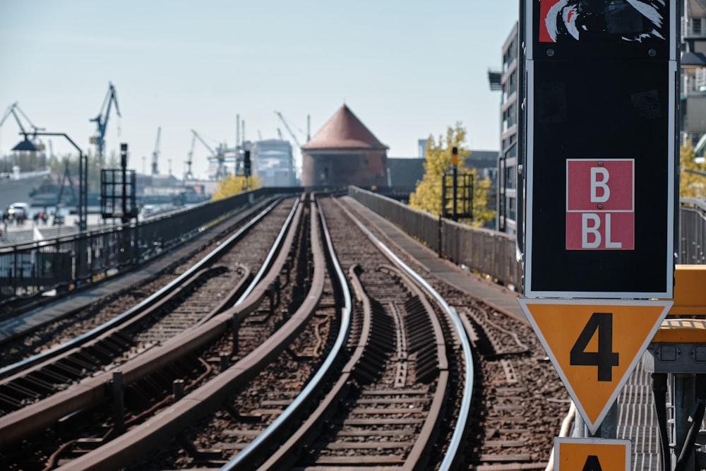 a train track with a sign on the side of it