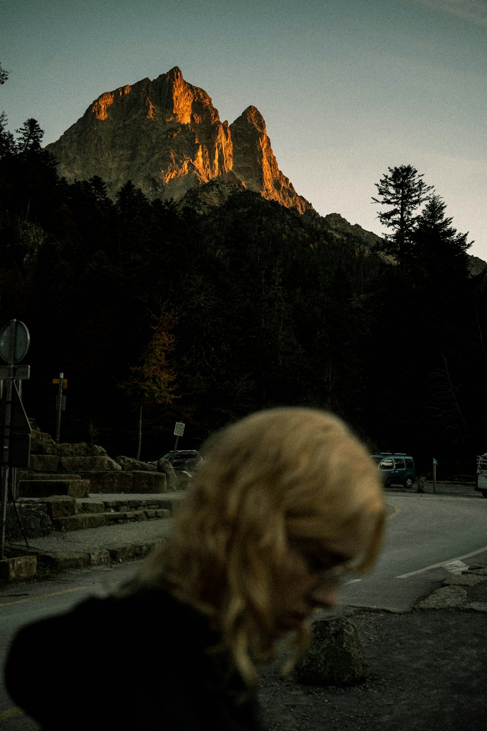 a woman standing in front of a mountain