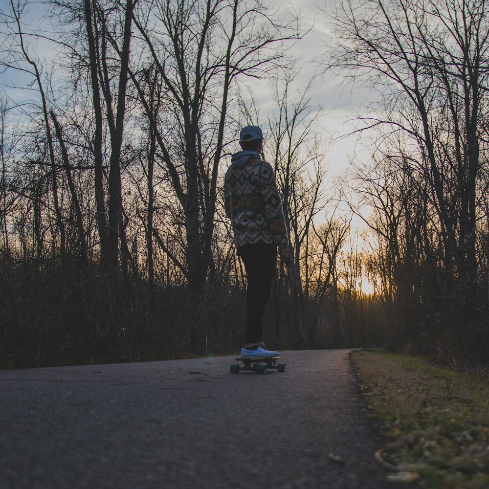 a person riding a skateboard down a road