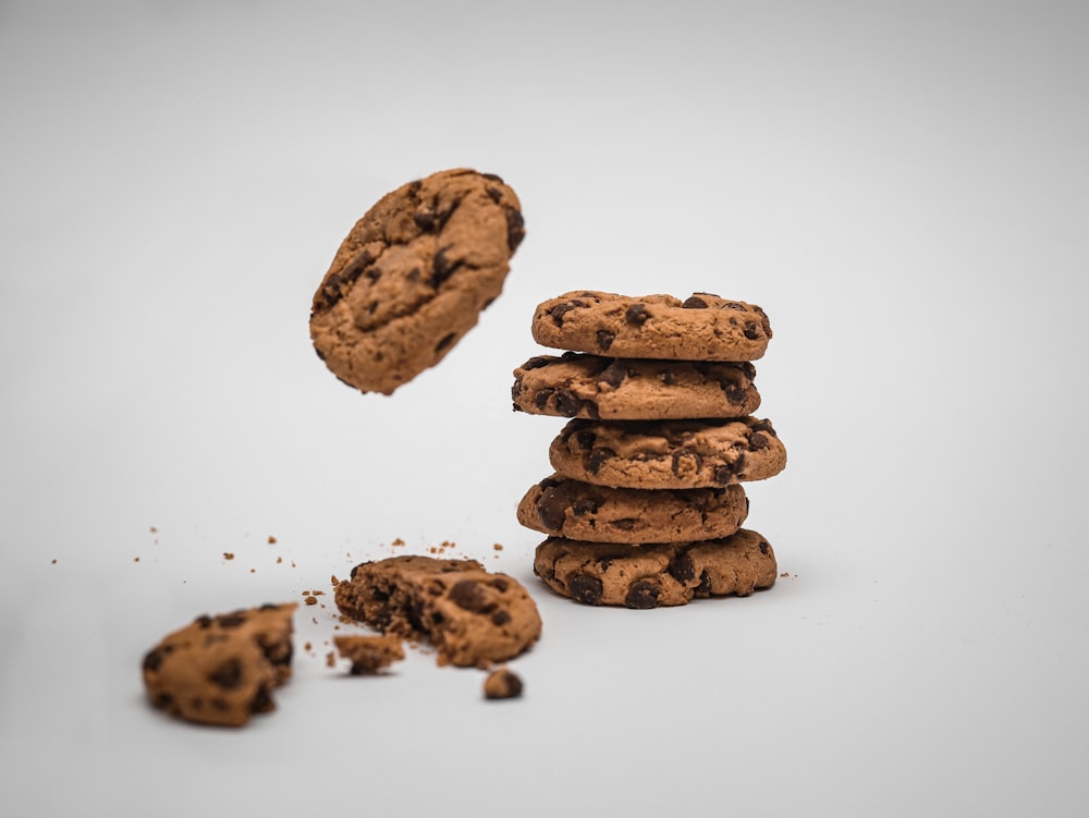 a pile of chocolate chip cookies with a bite taken out of one