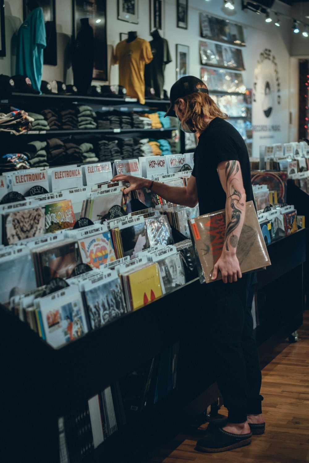 a man standing in front of a store filled with books