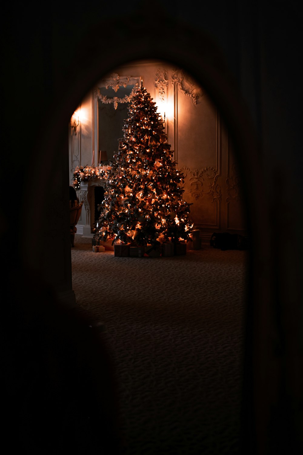 a christmas tree is lit up in a dark room
