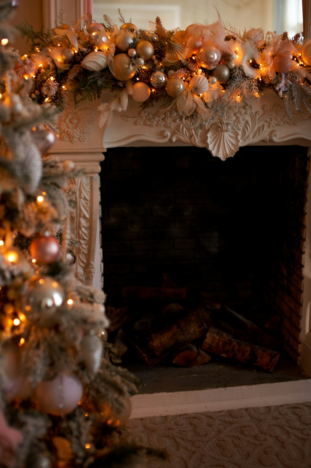 a decorated christmas tree in front of a fireplace