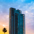 a tall building sitting next to a palm tree