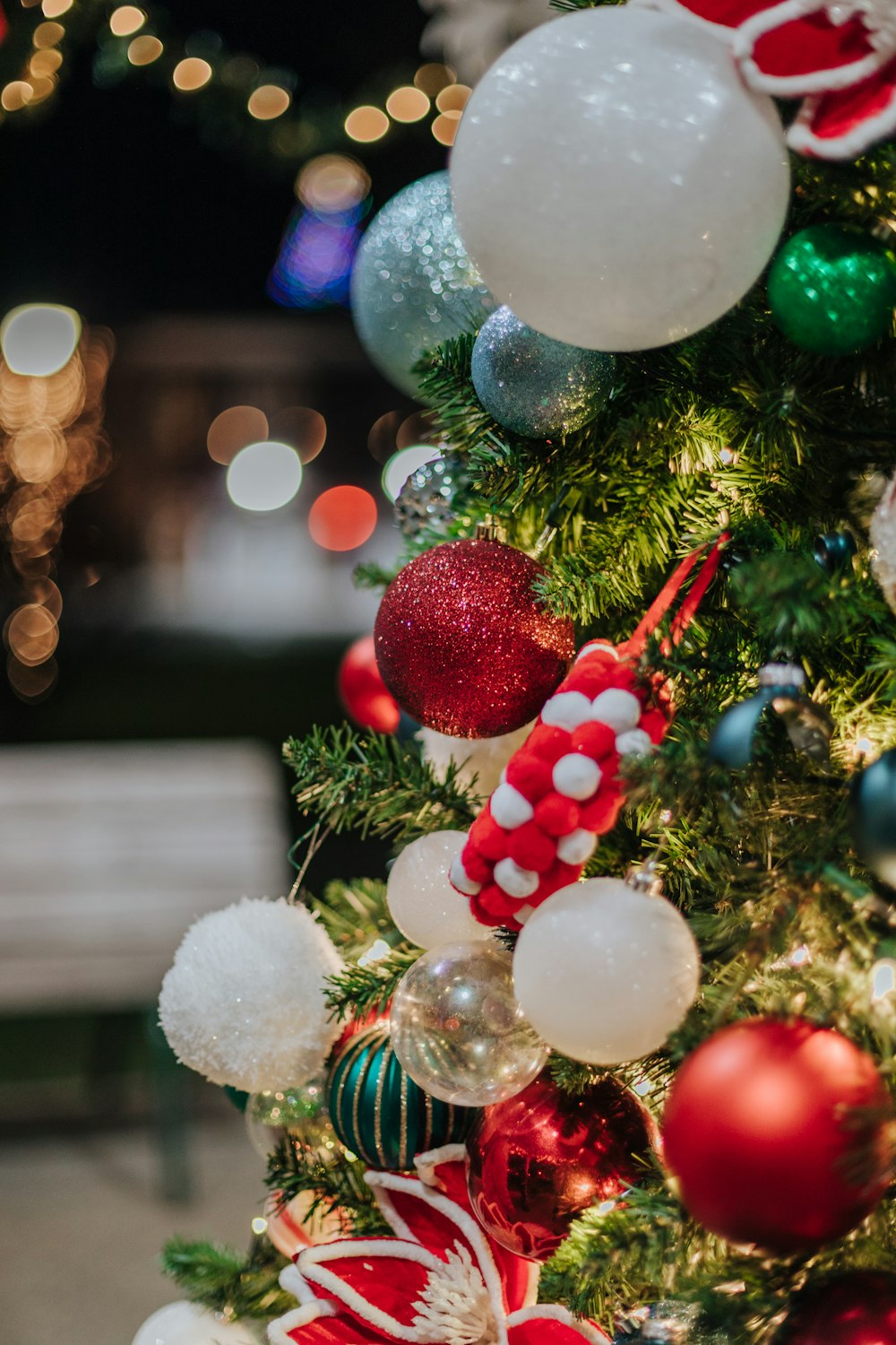 a christmas tree with ornaments and lights in the background