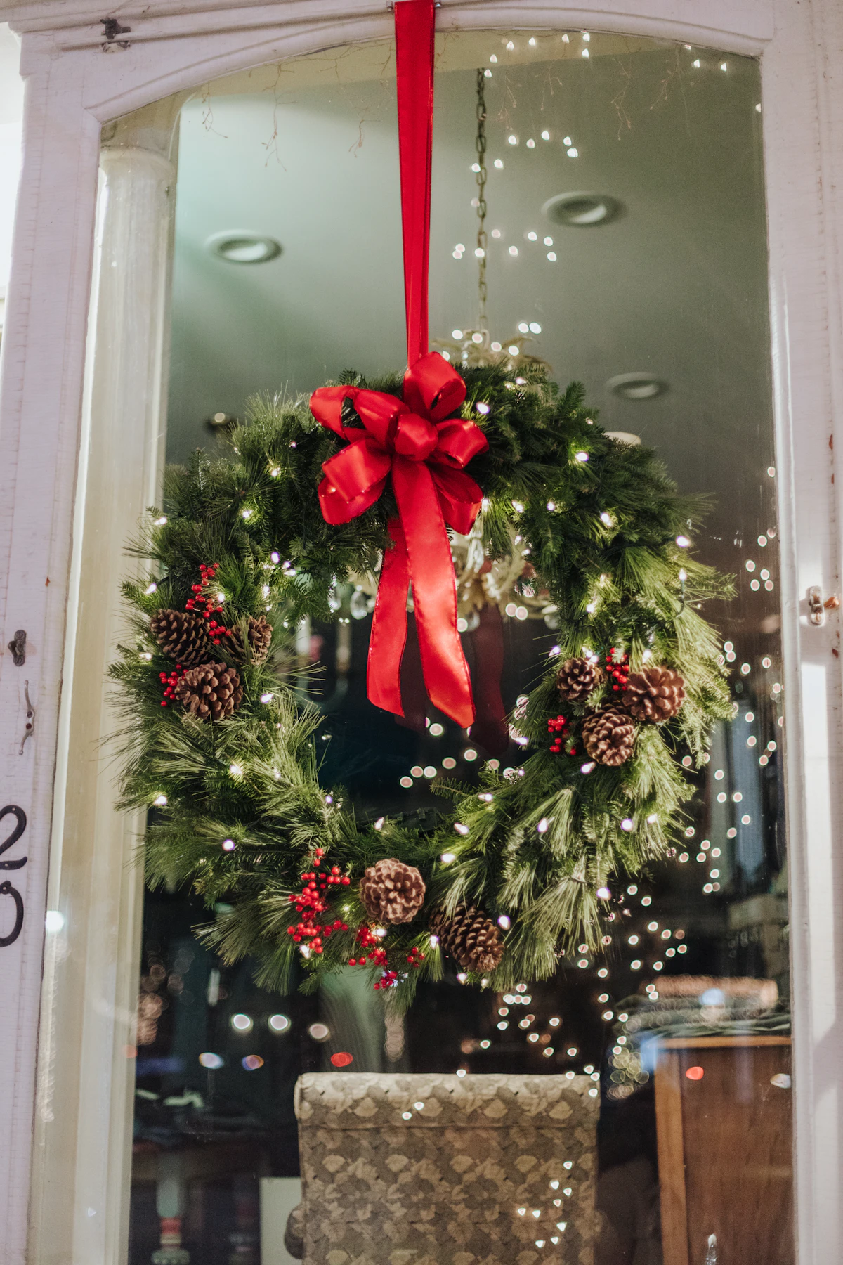 Christmas wreath with a red bow hanging in a doorway