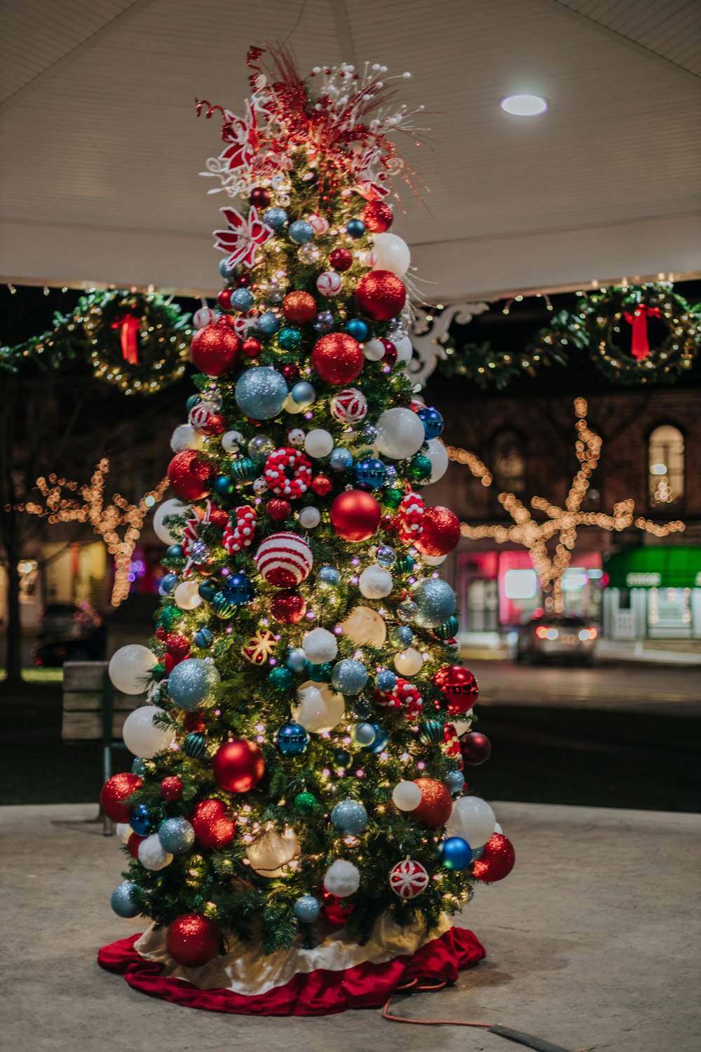 a brightly lit christmas tree in a shopping center