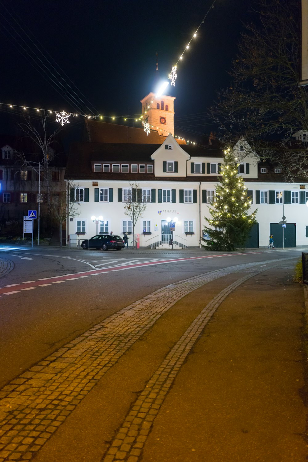 a large white building with a christmas tree in front of it