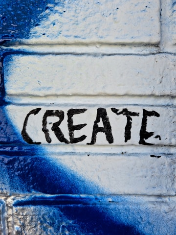 a blue and white painted brick wall with the word create painted on it