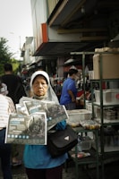 Volunteers distributing informational leaflets about workers' rights in a busy market.