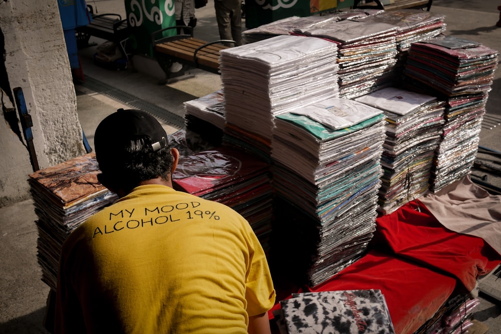 a man sitting next to a pile of papers