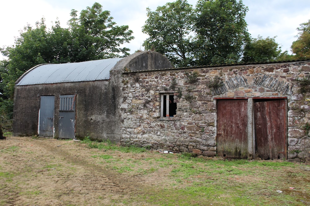 an old stone building with a metal roof