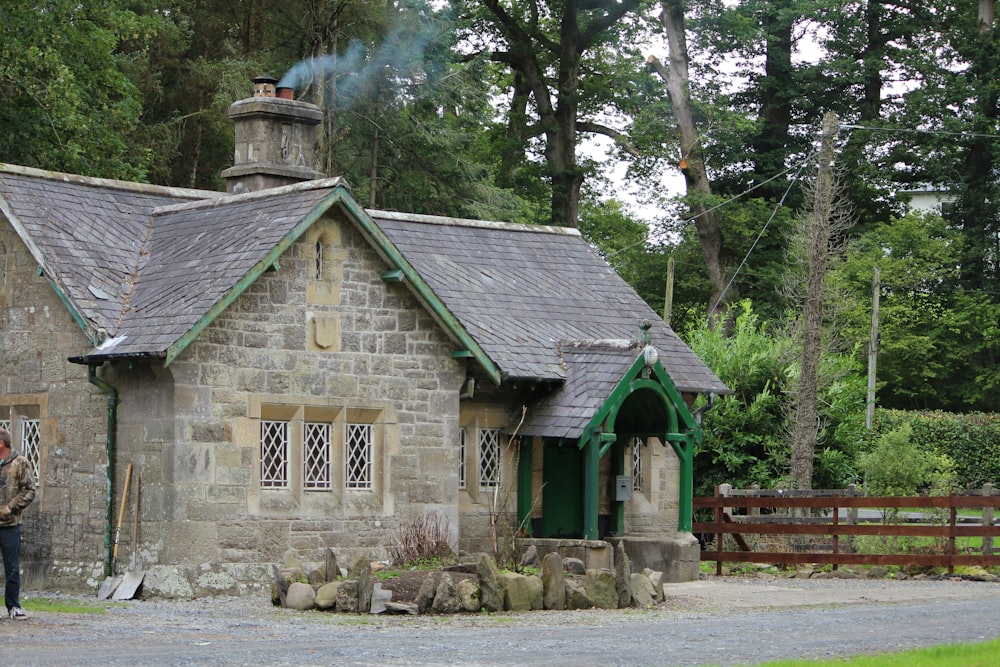 a man standing in front of a stone building