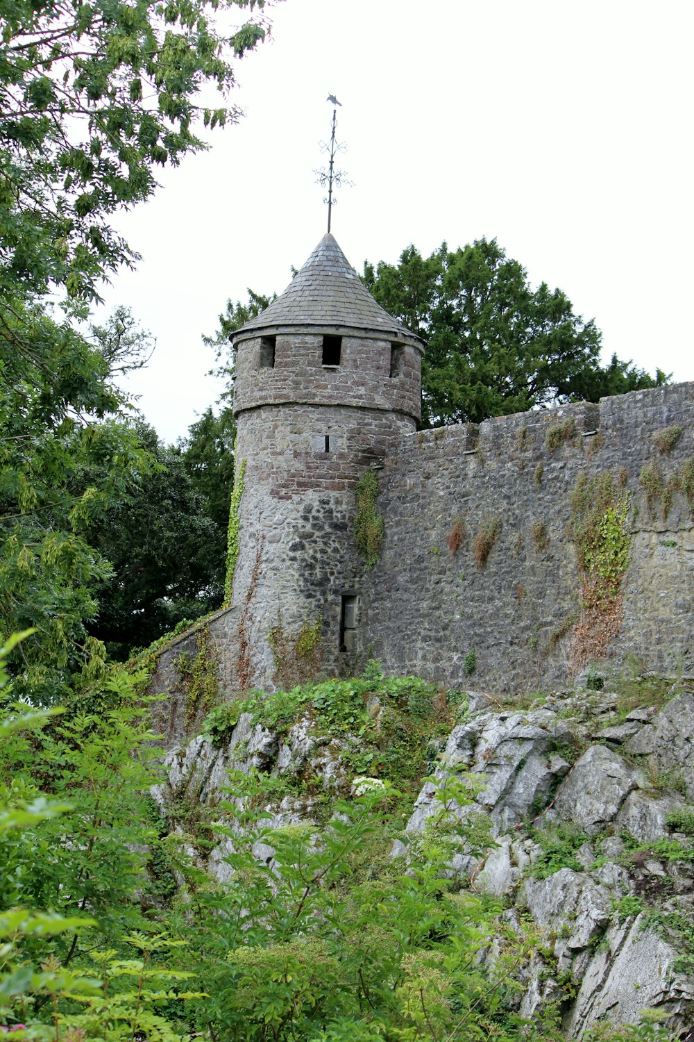 a stone tower with a clock on top of it