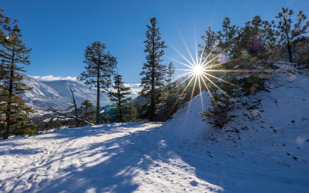 the sun shines brightly over a snow covered mountain