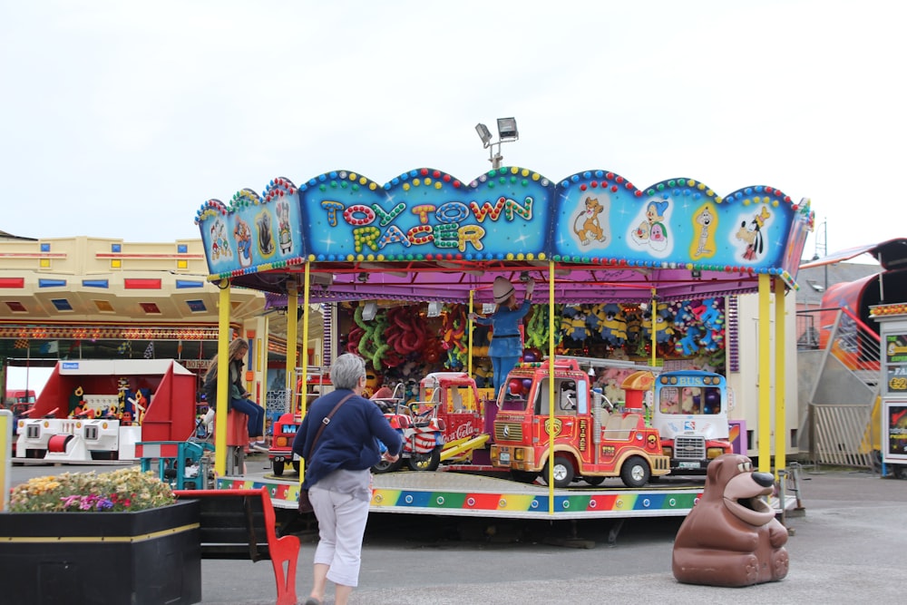 a carnival ride with a person standing next to it