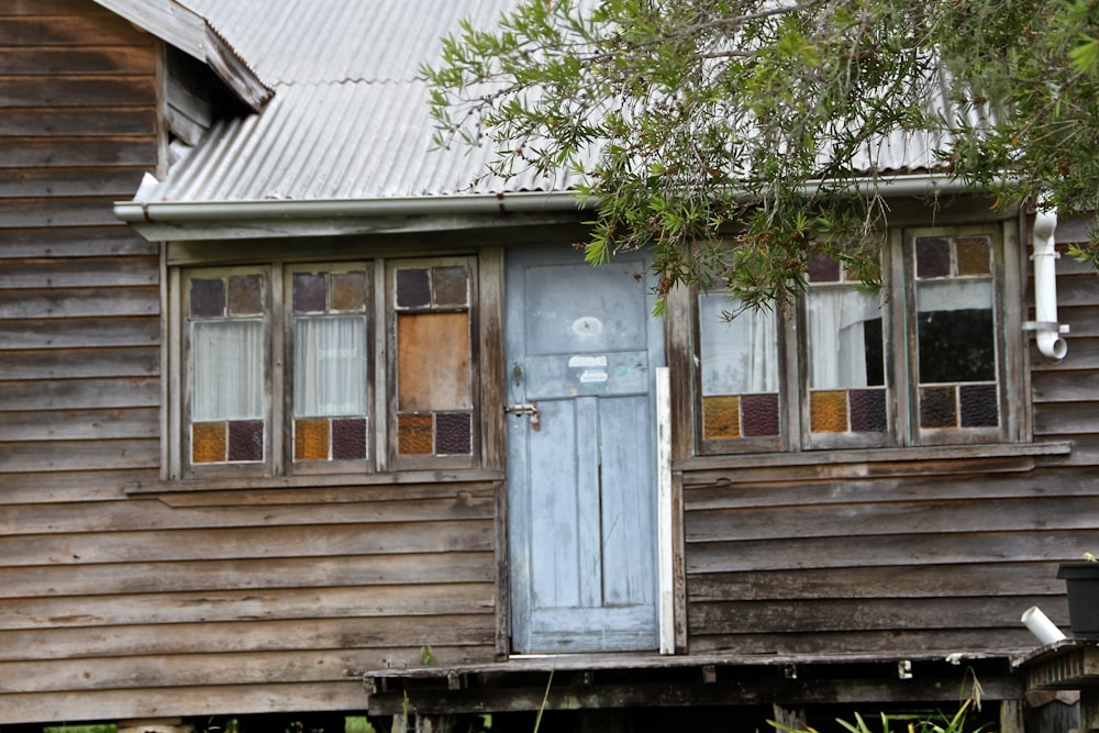 an old wooden house with a blue door