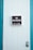 A close-up of a white paneled door with a 'No Trespassing' sign mounted in the center. The sign includes the text 'CPC sec 602(L)' in smaller print. The door is bordered by teal-colored framing, and a silver door latch is visible on the right side.