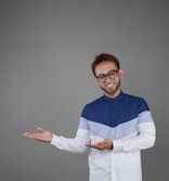 a man wearing glasses and a blue and white shirt