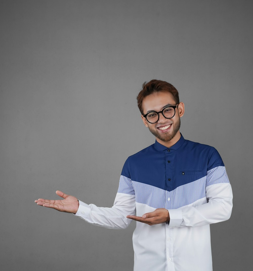 a man wearing glasses and a blue and white shirt