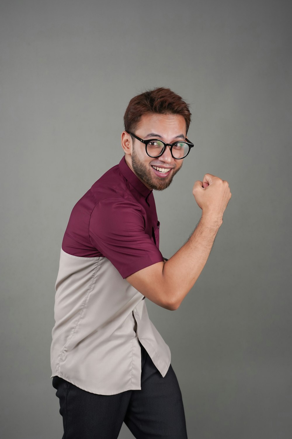 a man with glasses is posing for a picture