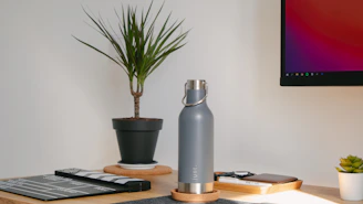 A sleek, minimalist workspace with large aesthetic photos showcasing plastic recycling processes.