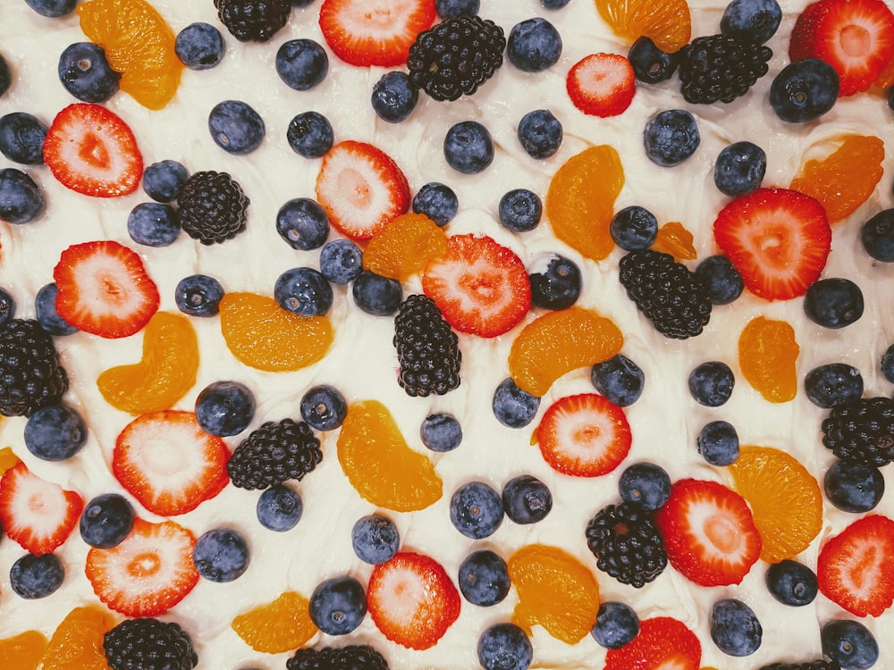 a close up of a cake with fruit on it