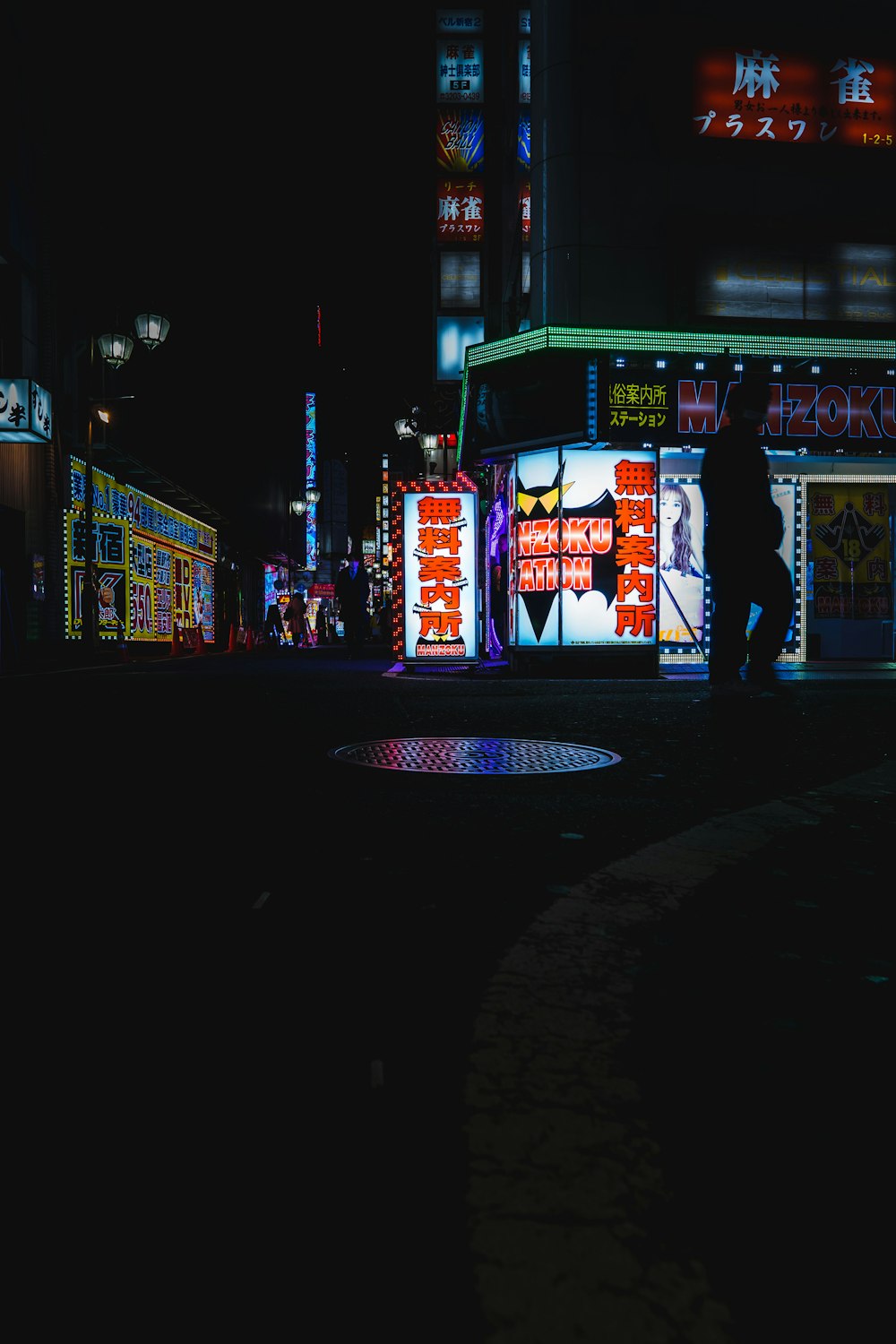 a man walking down a street at night