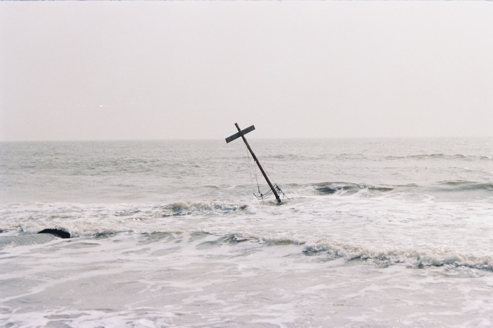 a cross in the middle of a body of water