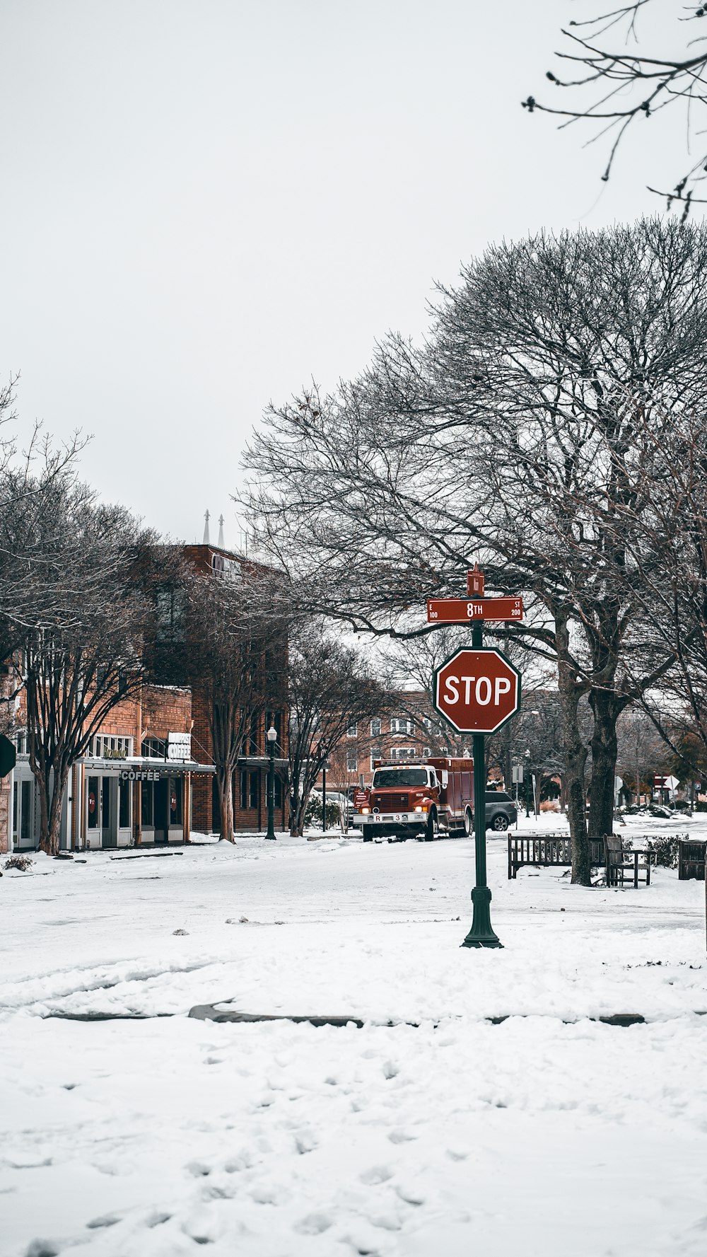 a stop sign in the middle of a snowy street