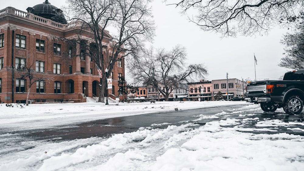 a truck is parked on a snowy street