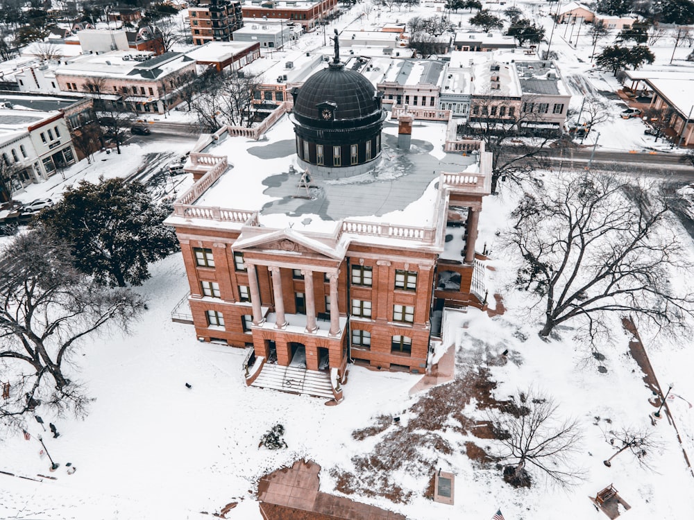 an aerial view of a building in the snow