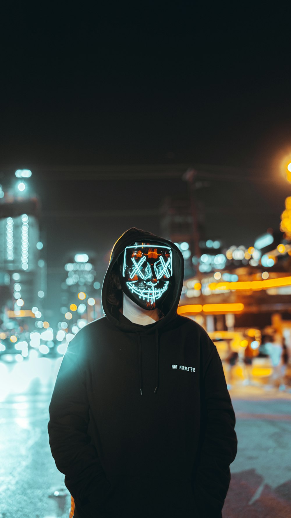 a person wearing a hoodie with a skull on it