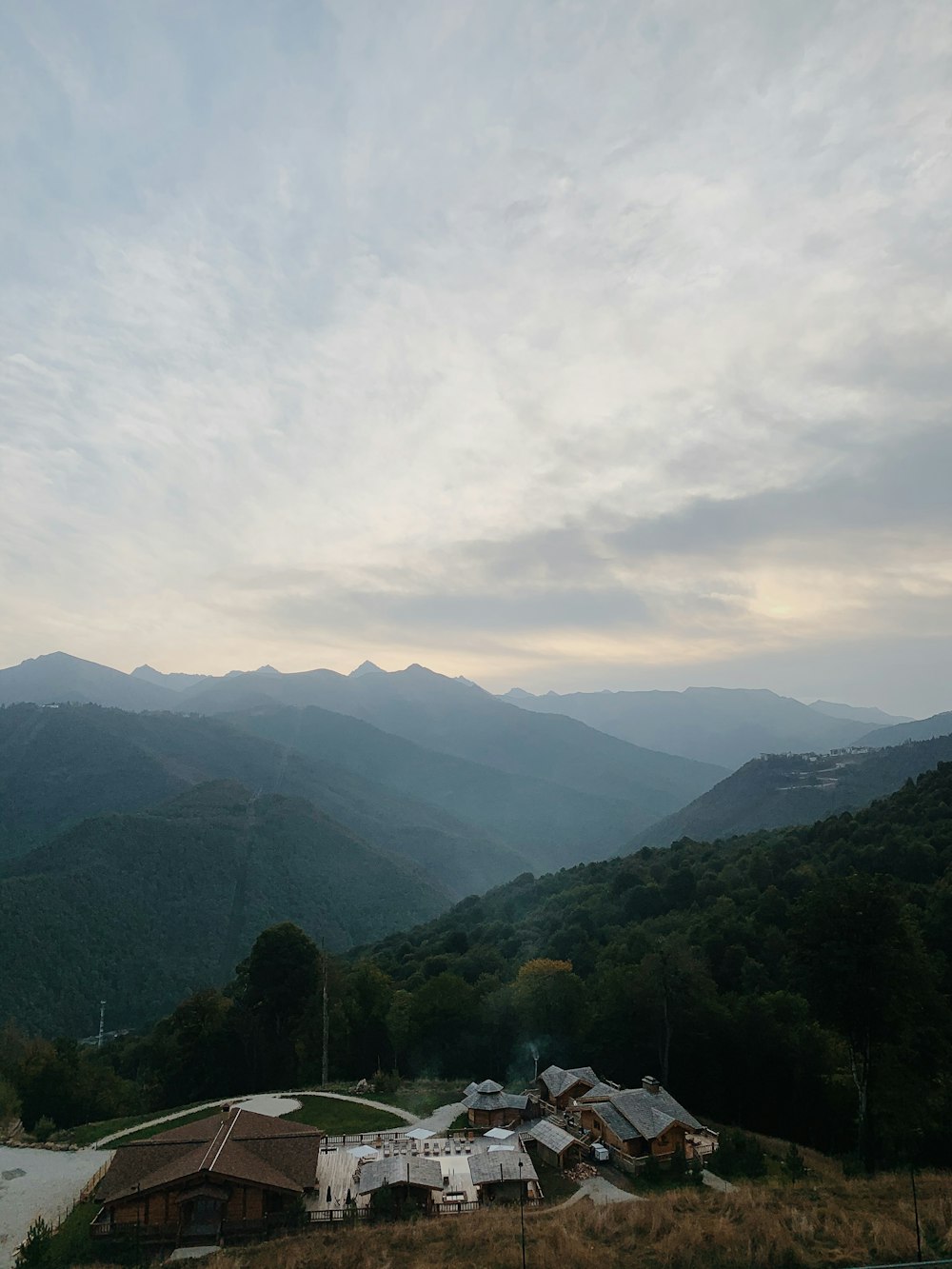 a view of a mountain range with houses in the foreground