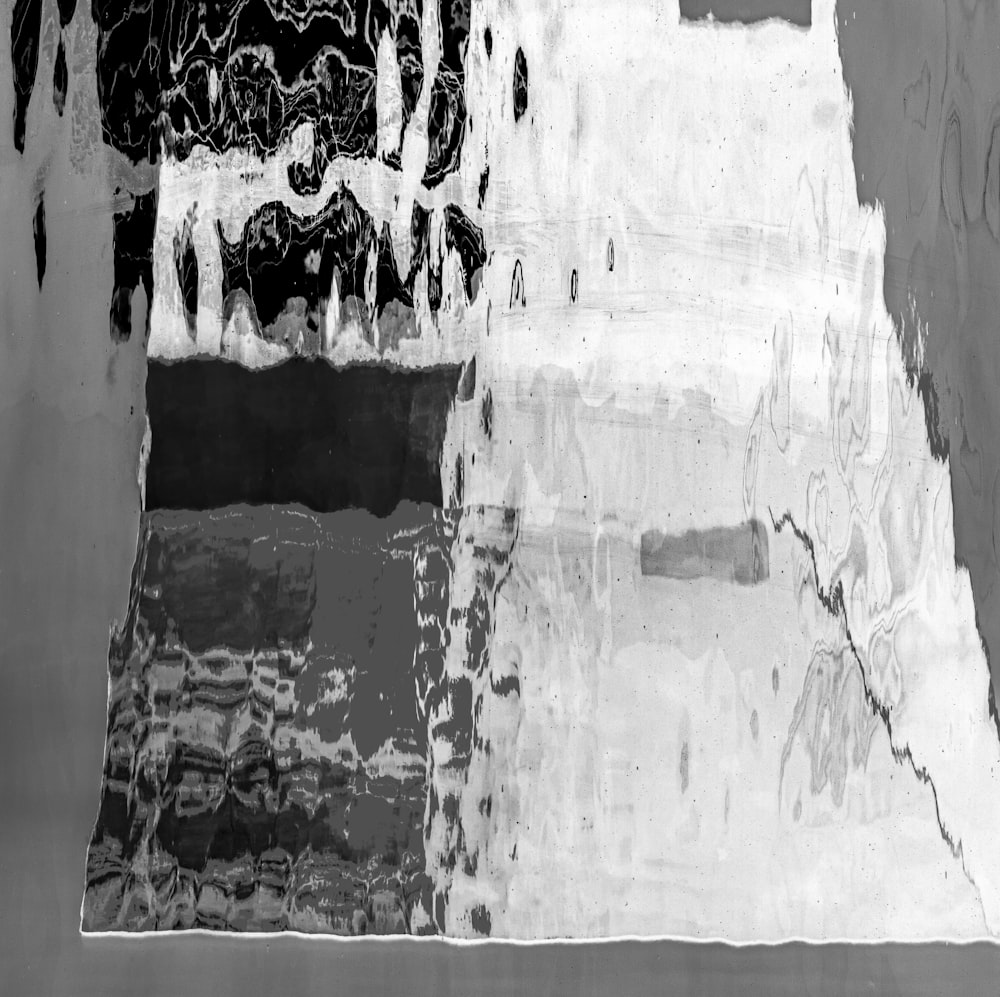 a black and white photo of ice and water