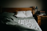Empty bed at night with soft fluorescent light — steady brown noise environment for anxiety relief