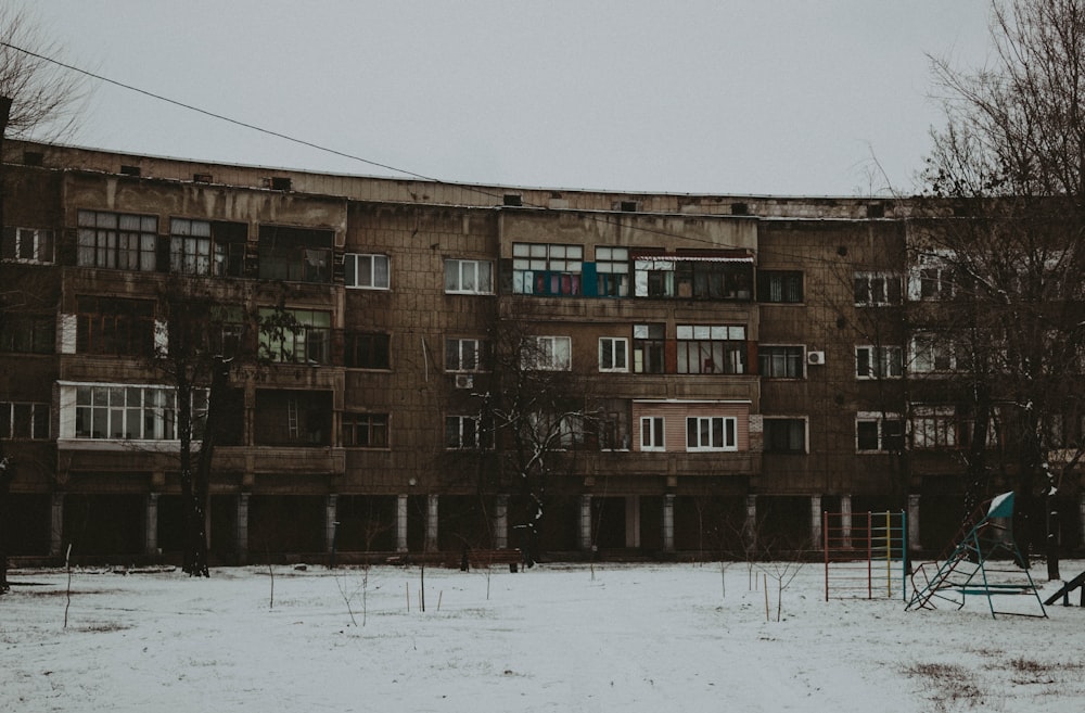 an old building with a playground in front of it