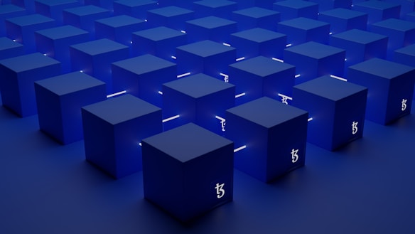 A series of identical blue cubes are arranged in a grid pattern on a flat surface. Each cube is illuminated with a subtle light, casting soft shadows. A symbol resembling the Tezos blockchain logo is visible on the sides of the cubes.