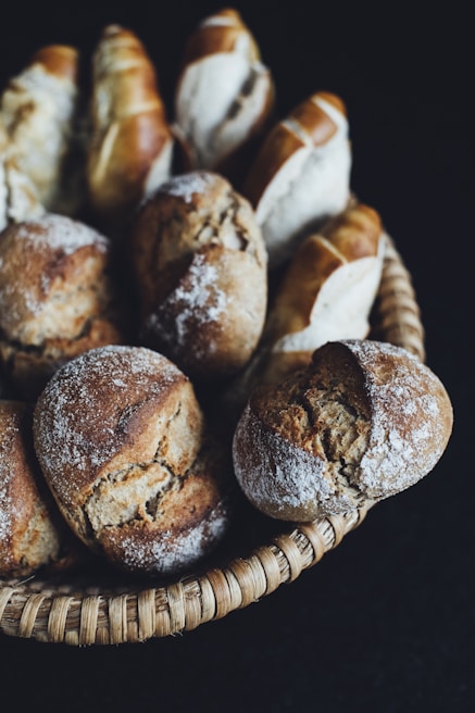 A rustic basket filled with assorted whole-grain breads and rolls