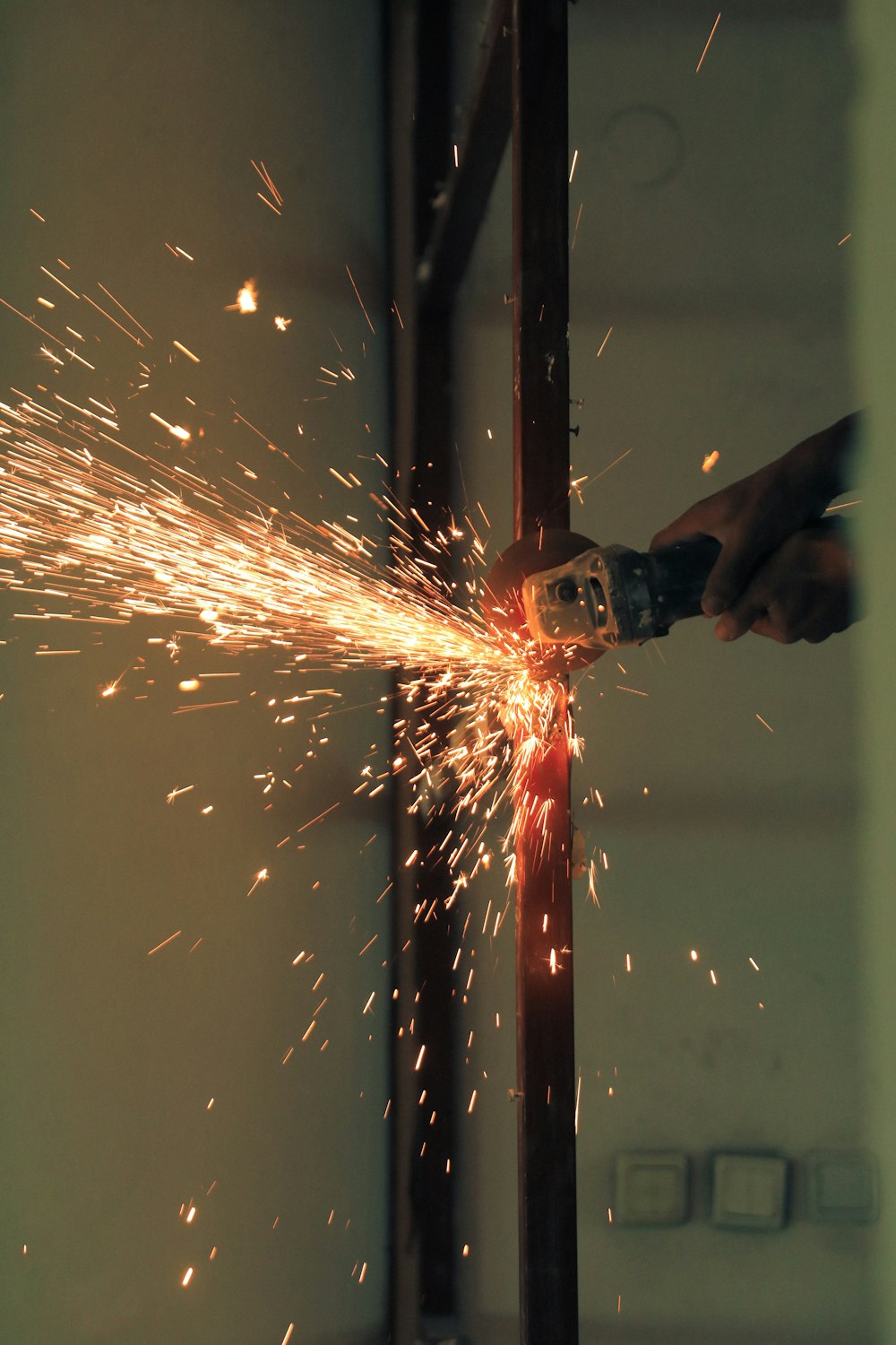 a person using a grinder on a piece of metal