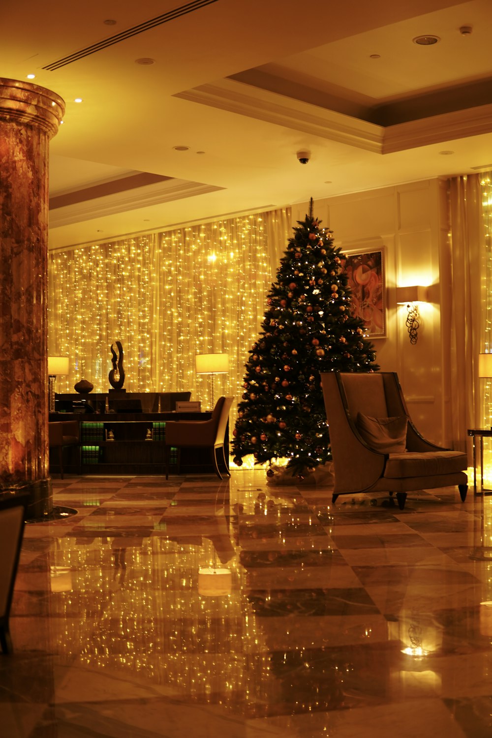 a christmas tree in the middle of a hotel lobby
