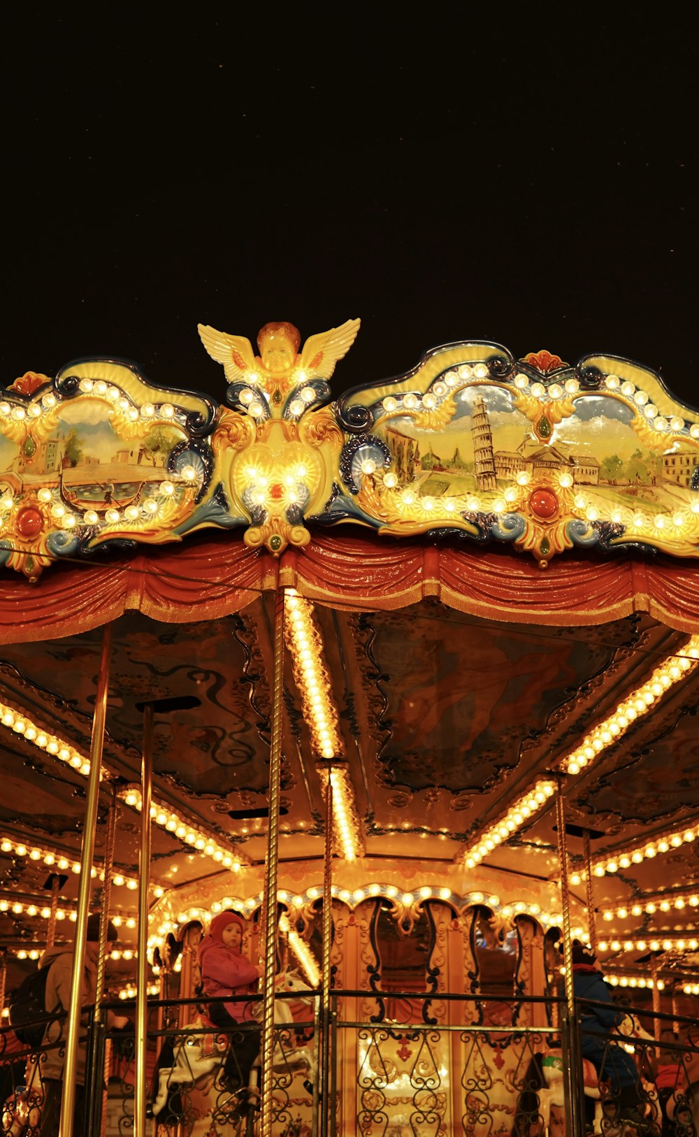 a merry go round is lit up at night