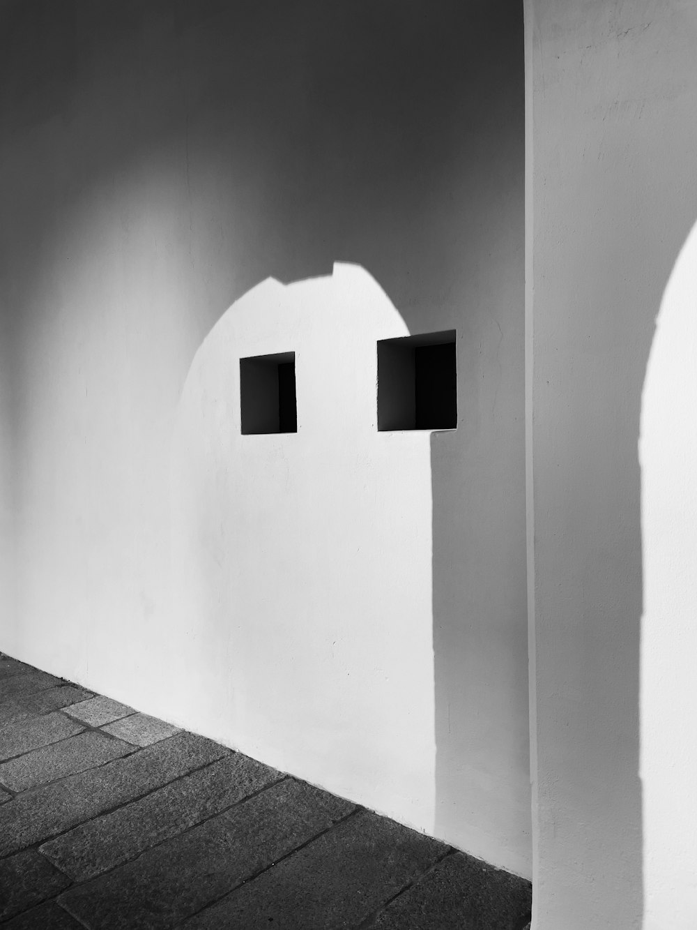 a black and white photo of two square windows