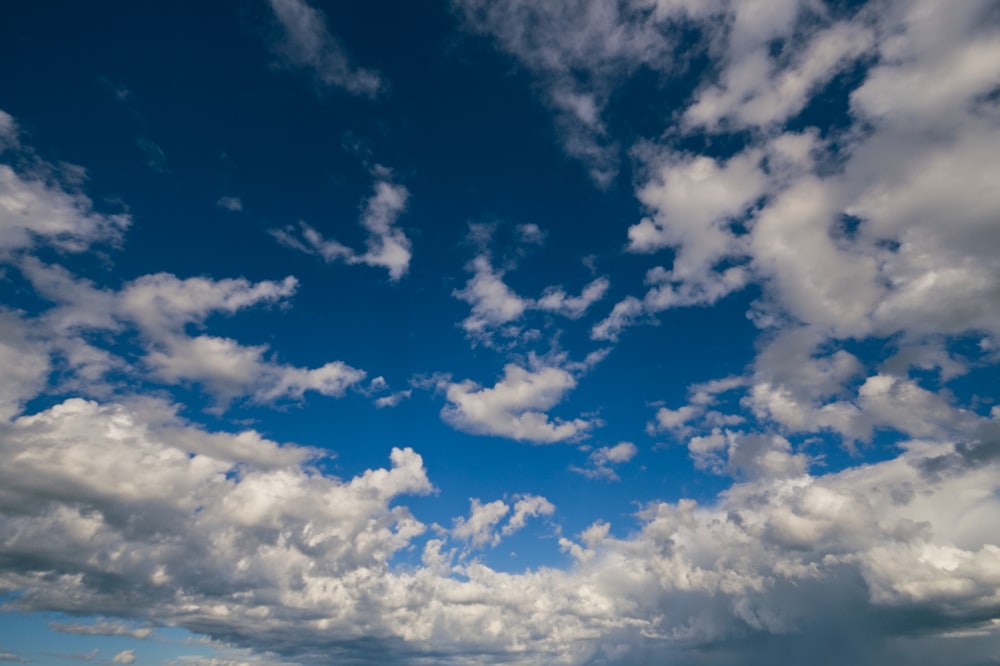 a large body of water under a cloudy blue sky