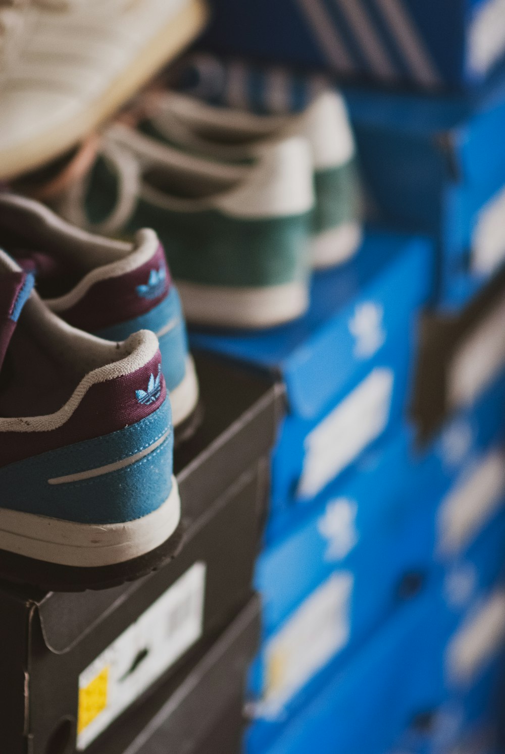 a pair of shoes sitting on top of a stack of boxes