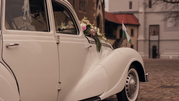 a white car with flowers on the side of it