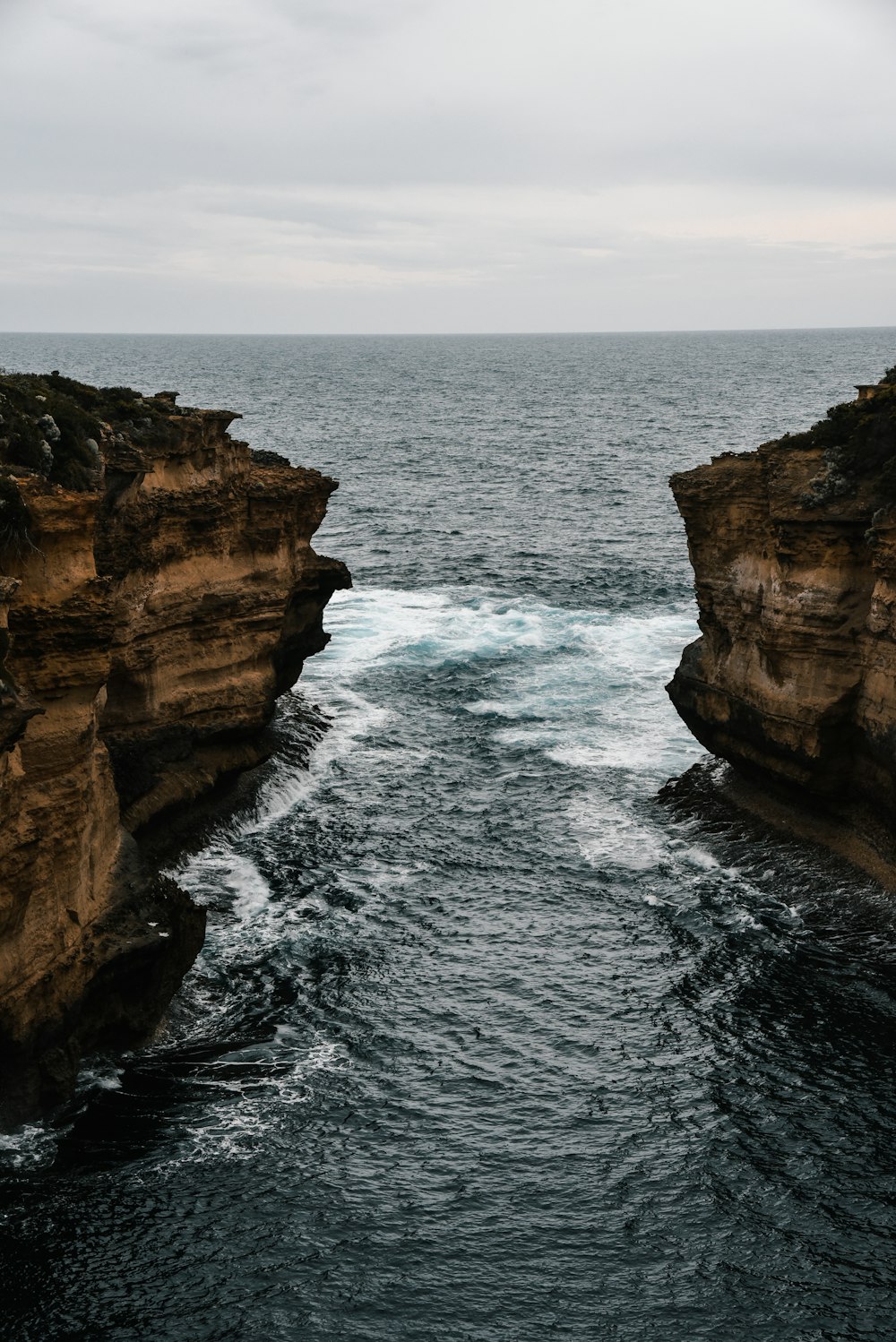 a rocky island in the middle of a body of water