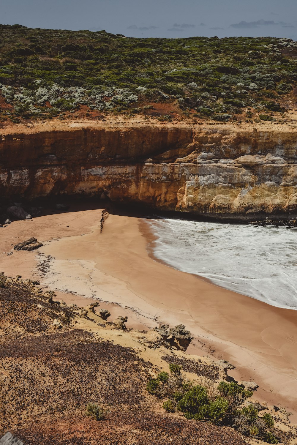 a rocky beach next to a body of water